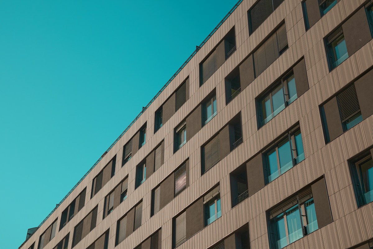 Residential condominium facade with balconies and greenery in Belgrano